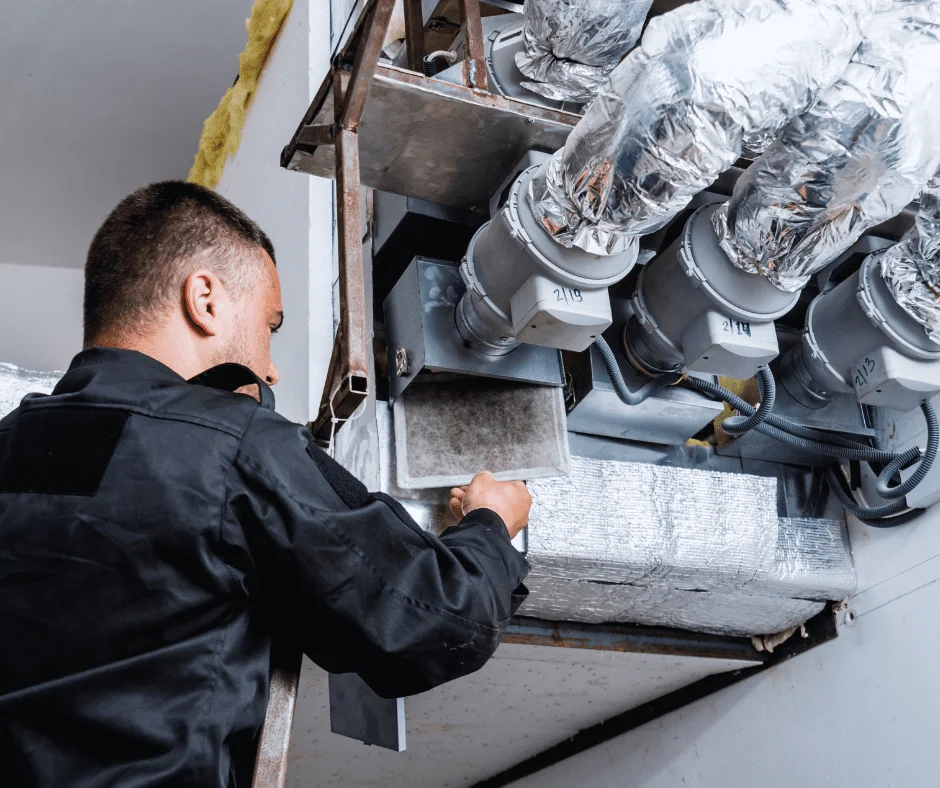 Technician replacing a dirty air filter during professional HVAC mold remediation in Charlotte, NC.