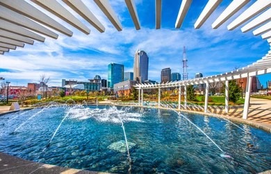 Charlotte NC skyline and park fountain during heavy rainfall season and moisture prep.